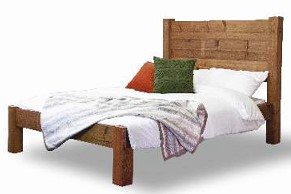 A wooden bed with low foot end